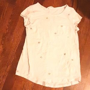 White tee with silver stars and small pocket.